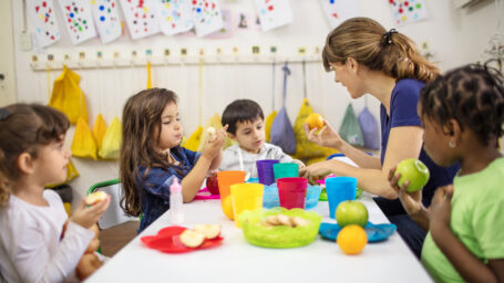 Nutritionist teaching children about healthy foods