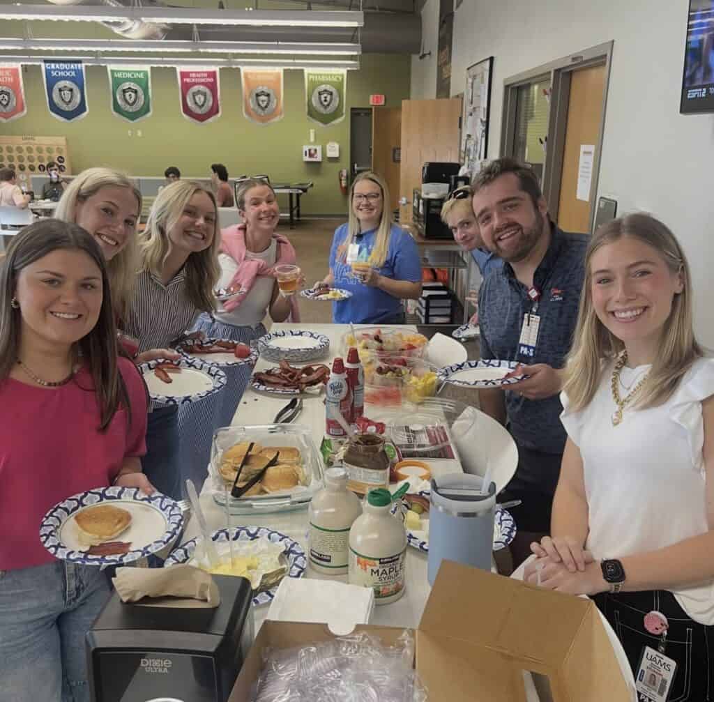 PA students enjoy food prepared for them by the faculty