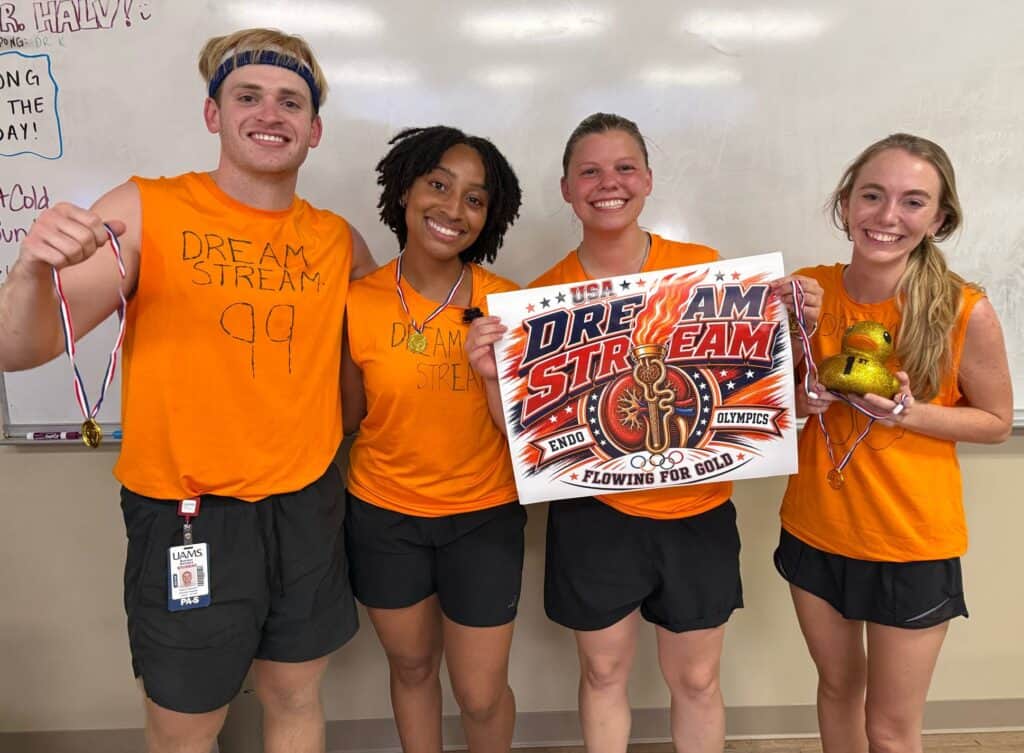 A group of PA students dressed in orange holding a sign that says Dream Stream