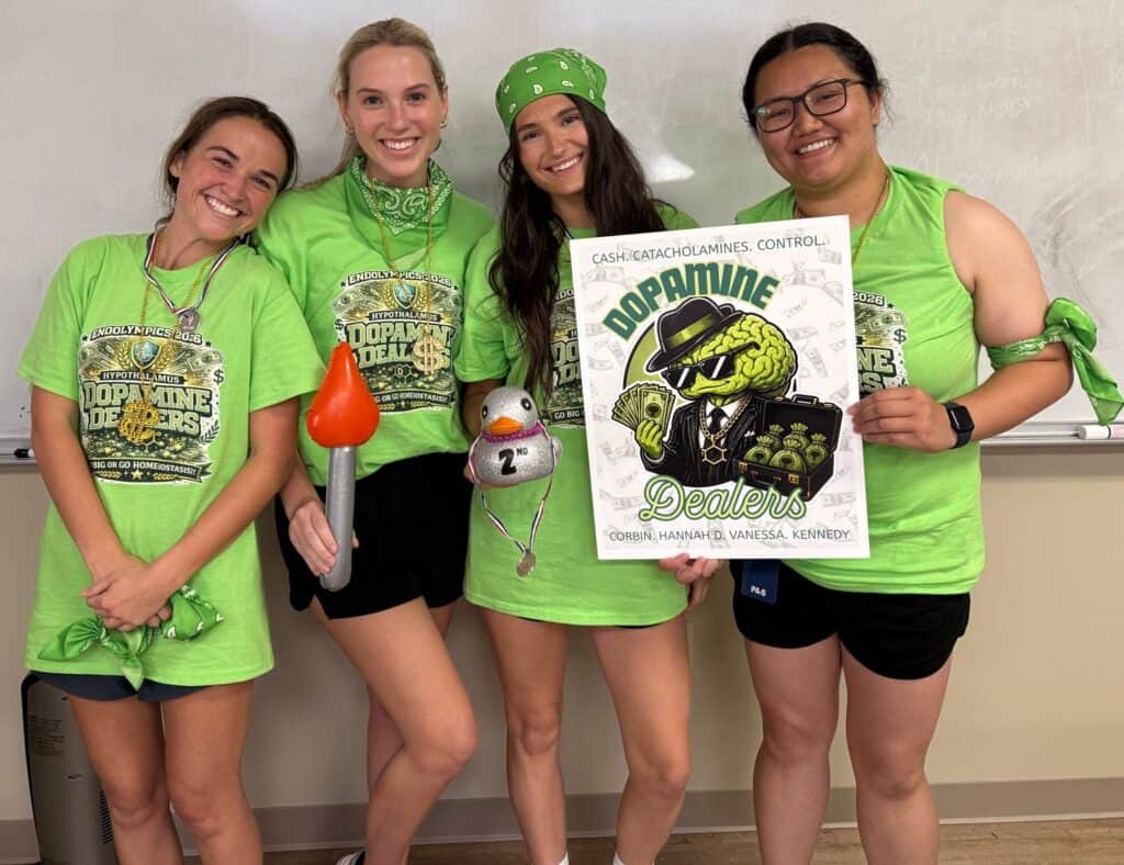 Four PA students dressed in green holding a sign that says Dopamine Dealers