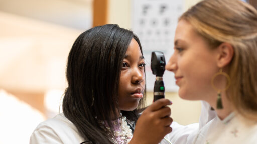 A physician assistant examining a patient