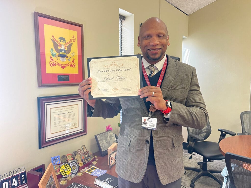 Edward Williams holding his Core Values award