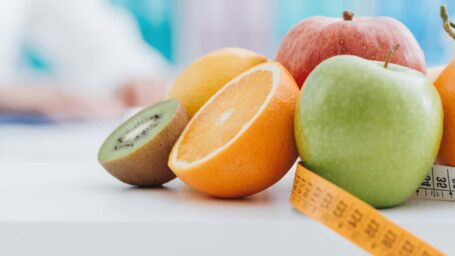 Fruit on a table with a tape measure