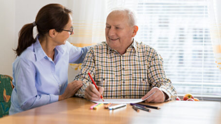 Home caregiver and senior adult man