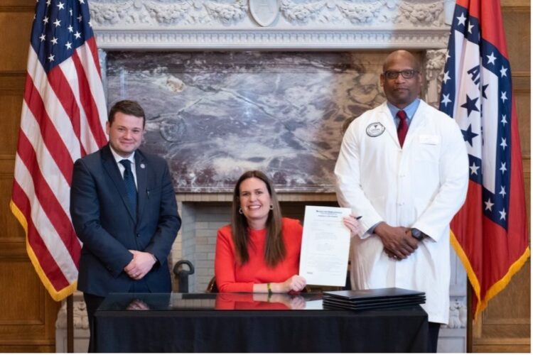 Official Signing of Act 303  Left to right: Rep. Pilkington, Governor Huckabee-Sanders, Dr. Williams UAMS PA Program Director 